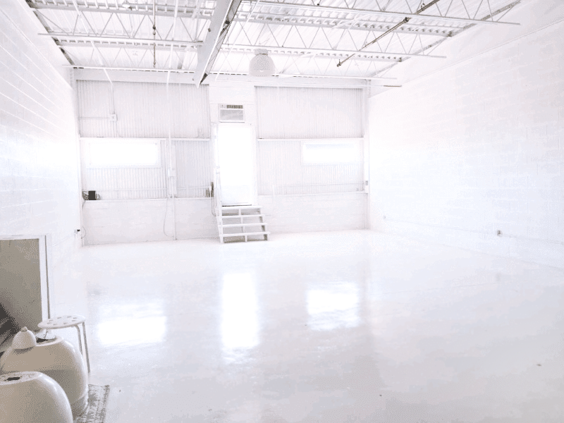 a picture of white studio with lights boxes stool